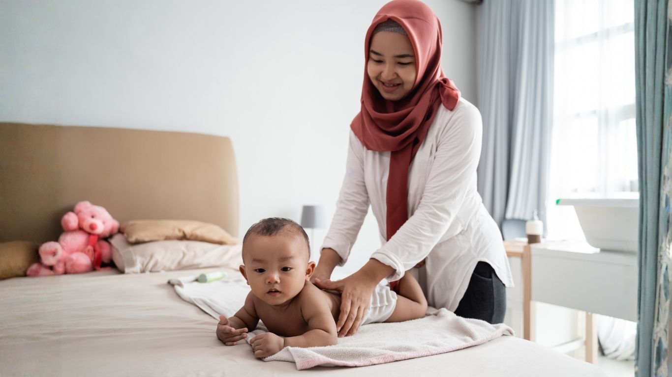 Ibu merawat bayi dengan lembut dan profesional